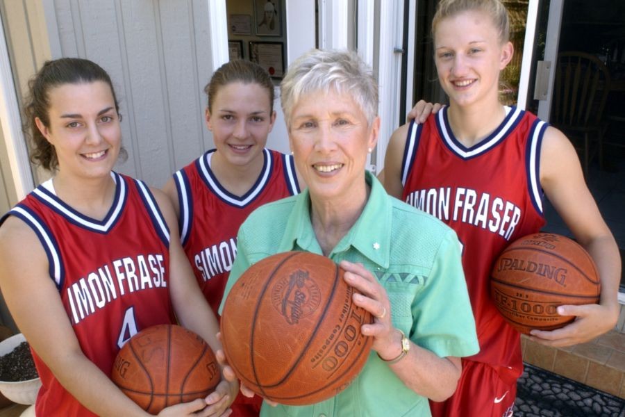 Barbara Rae with members of SFU Women's basketball team