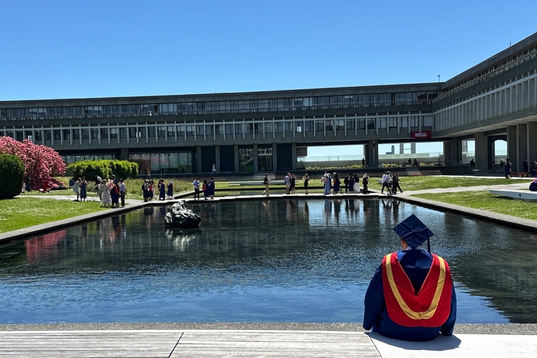 Image: Graduate sitting near the Reflection Pond